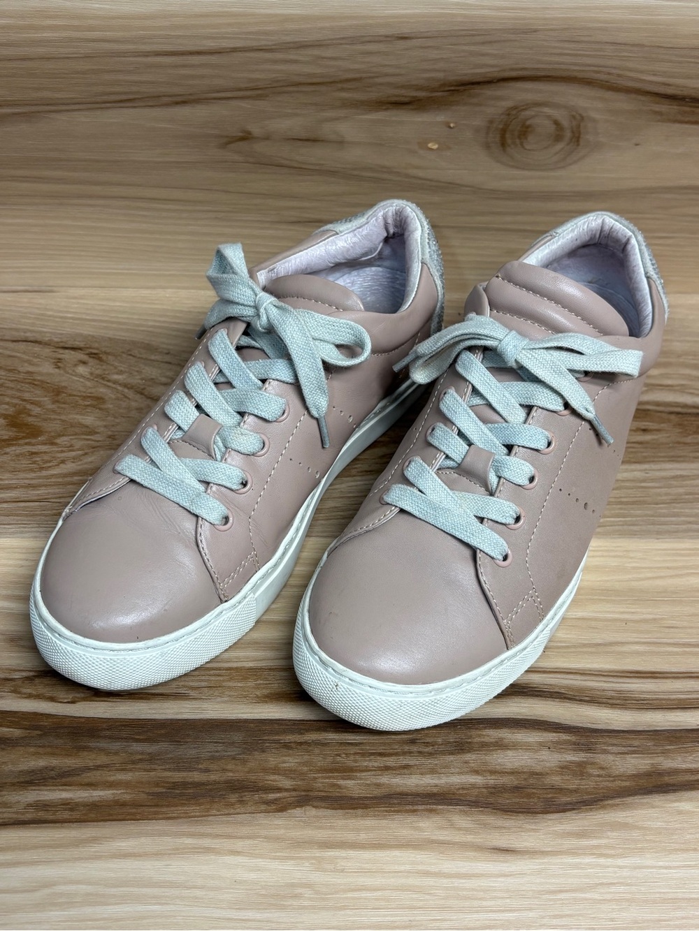 Lola Cruz blush pink leather sneakers featuring rhinestone smiley face heel 9